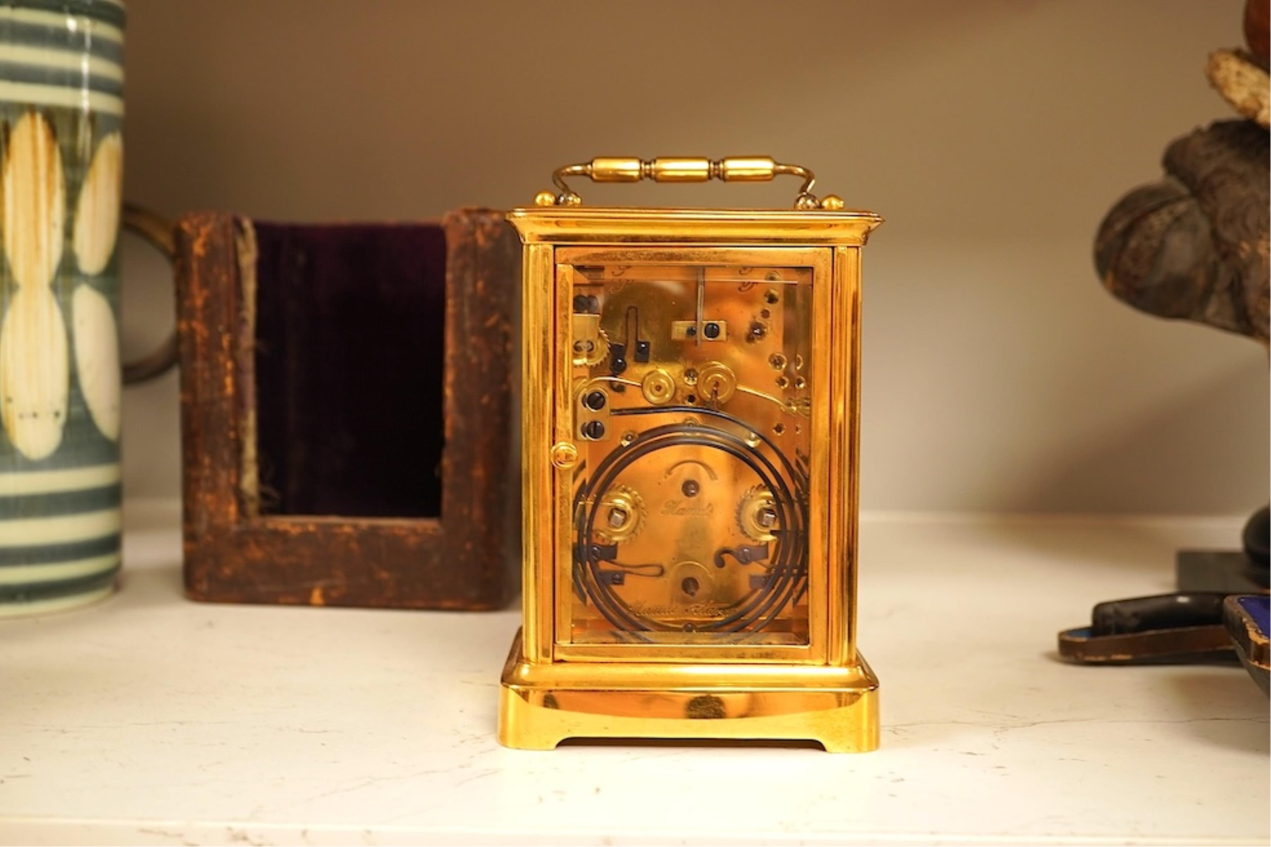 A French carriage clock with alarm, gong-striking movement, in a contemporary leather case, 17cm high